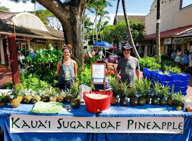 341453502_537949975185556_825367203733197548_n a group of people standing in front of a fruit stand